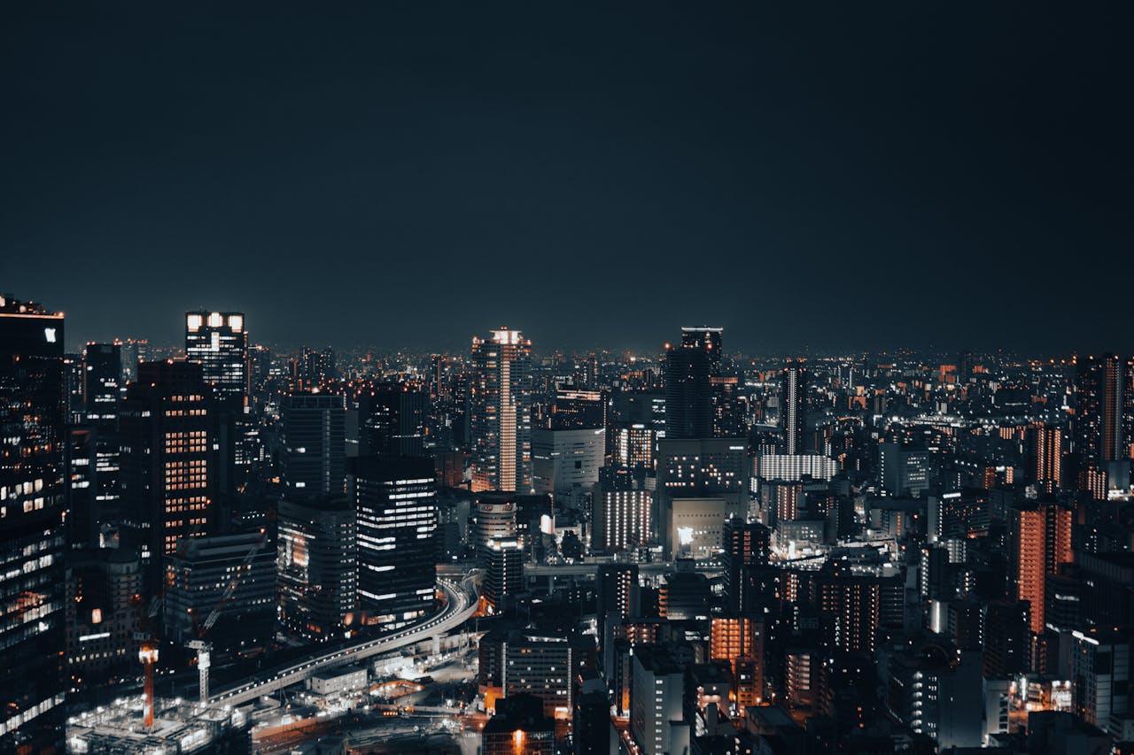 A captivating nighttime cityscape showcasing a vibrant urban skyline with illuminated buildings.